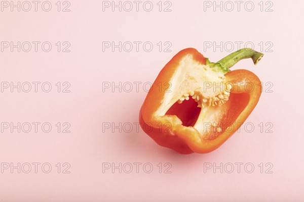 Red Cutted pepper on pink pastel background. Side view, copy space. Tropical, healthy food, vegetable, slice, minimalism