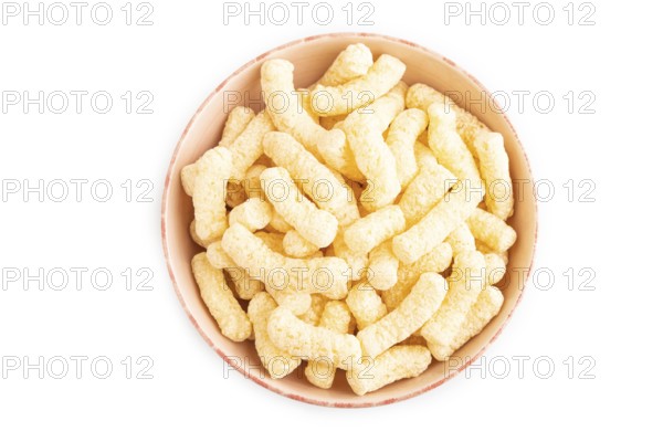 Corn flakes sticks with caramel in ceramic bowl isolated on white background. top view, flat lay, close up