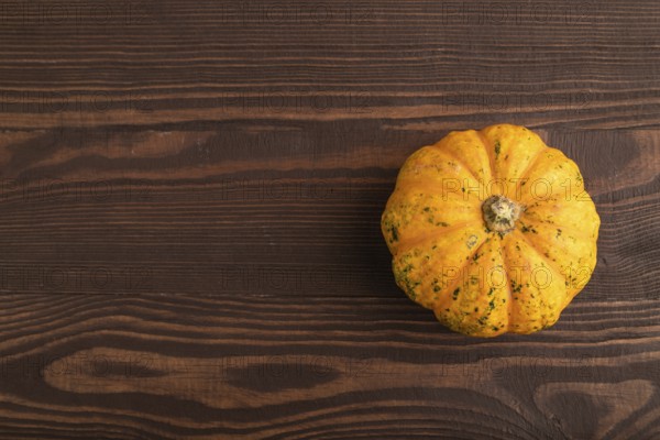 Orange Pumpkin on brown wooden background. Top view, copy space, flat lay. healthy food, vegetable, minimalism
