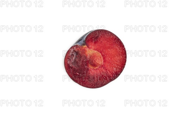 Purple Plum Cut in half isolated on white background. Top view, flat lay, copy space. healthy food, vegetable, minimalism