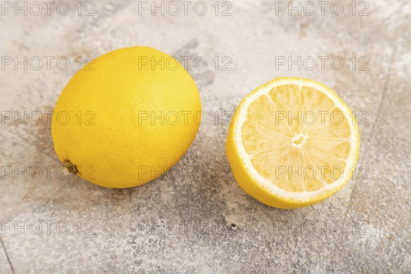 Yellow Lemon Cut in half on brown concrete background. Side view, close up, healthy food, vegetable, minimalism. citrus