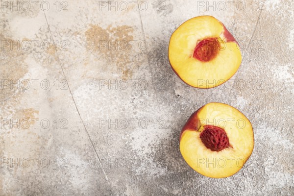 Peach Cut in half on brown concrete background. Top view, flat lay, copy space. healthy food, vegetable, minimalism