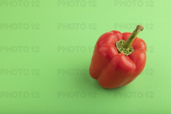Red pepper on green pastel background. Side view, copy space. healthy food, vegetable, minimalism