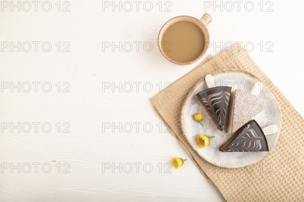 Chocolate and Vanilla Cake pops Marshmallow with cup of coffee on white wooden background and beige linen textile. top view, flat lay, copy space