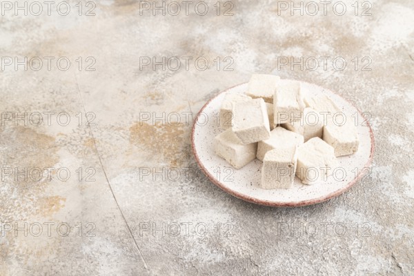 Coffee marshmallow on brown concrete background. side view, copy space