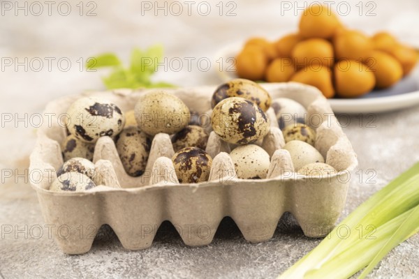 Pile of Smoked Quail eggs on plate on a brown concrete background. side view, close up, selective focus
