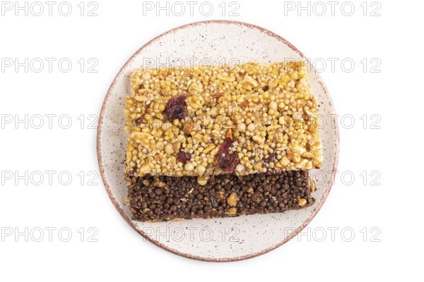 Granola bars with caramel, nuts, flakes in ceramic plate isolated on white background. Top view, flat lay, close up