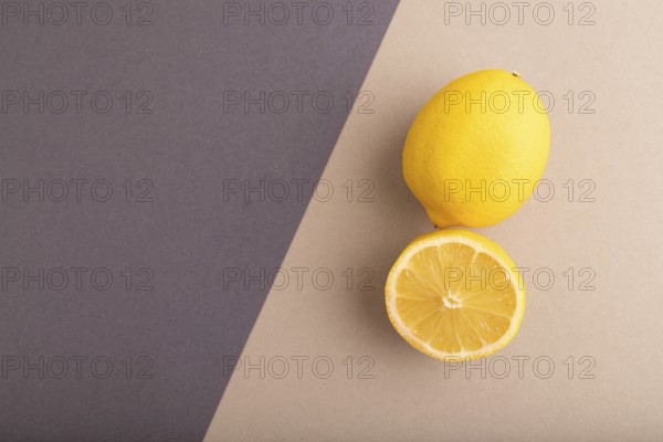 Yellow Lemon Cut in half on beige and gray pastel paper background. Top view, flat lay, copy space. healthy food, vegetable, minimalism