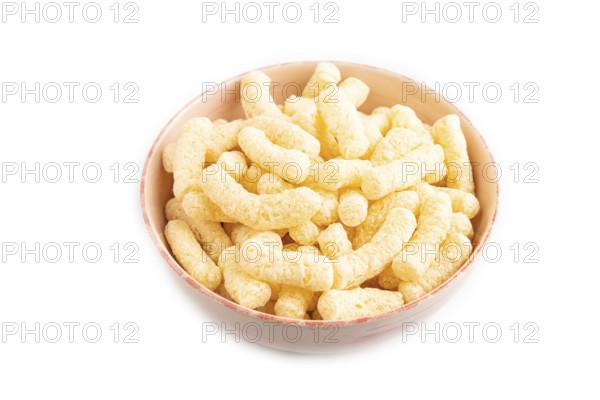 Corn flakes sticks with caramel in ceramic bowl isolated on white background. Side view, close up