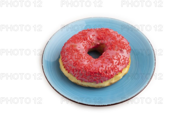 Pink Donut with sprinkles on blue ceramic plate isolated on white background, side view, close up, minimalism