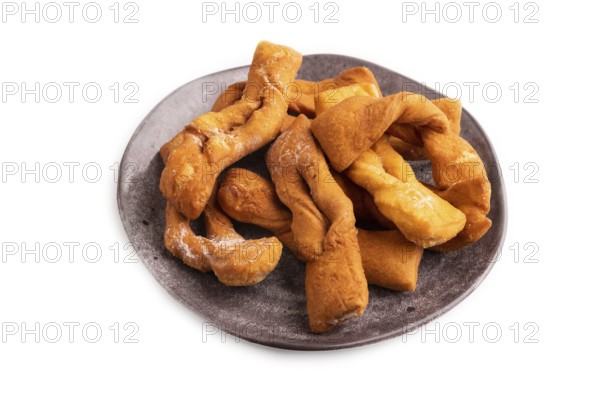 Crunchy biscuit Brushwood cookies sprinkled with powdered sugar isolated on white background, side view, close up