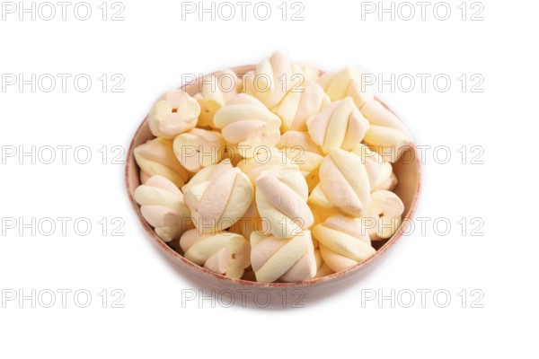 Orange and pink marshmallow in ceramic bowl isolated on white background, side view, copy space, minimalism