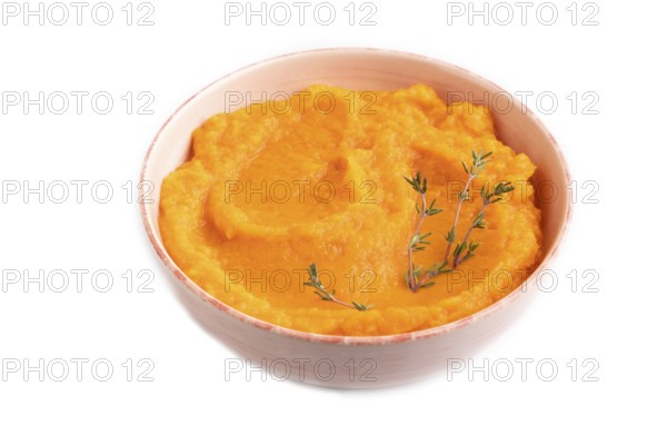Sweet potato porridge in ceramic bowl isolated on white background. Diet, healthy eating concept. side view, close up