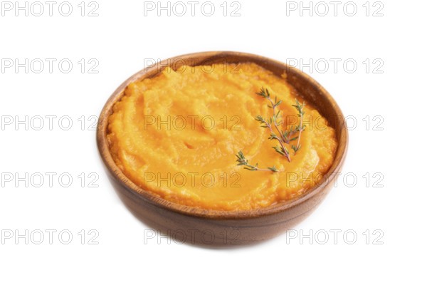 Sweet potato porridge in wooden bowl isolated on white background. Diet, healthy eating concept. side view, close up, minimalism