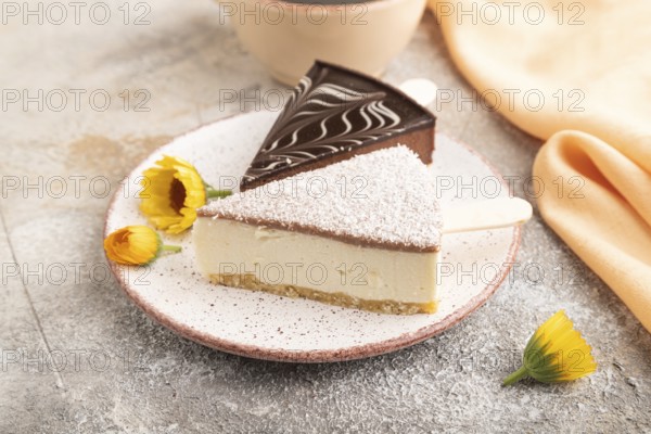 Chocolate and Vanilla Cake pops Marshmallow with cup of coffee on brown concrete background and orange linen textile. side view, close up