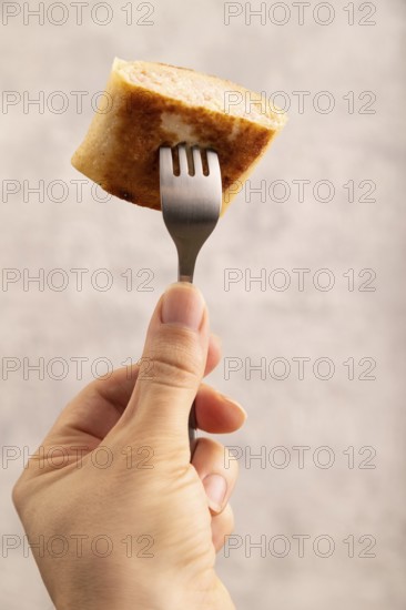 Fried crispy pancakes with meat and cheese with hand. side view, close up, selective focus