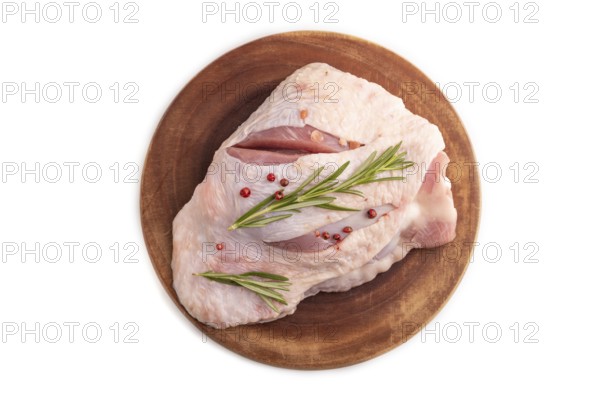 Raw Turkey Thigh with spices and rosemary on cutting board isolated on white background. top view, flat lay, close up