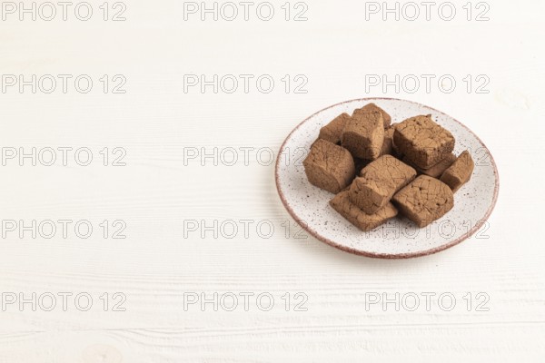 Chocolate marshmallow on white wooden background. side view, copy space