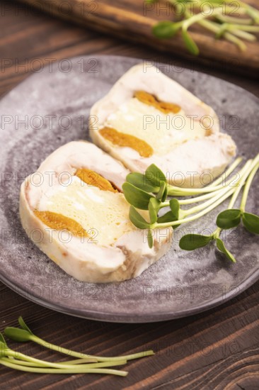 Chicken, egg and dried apricot meatloaf, microgreen on brown wooden. Diet, healthy eating. side view, selective focus