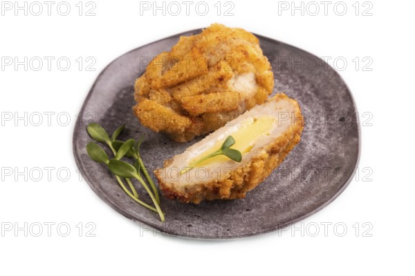 Chicken Schnitzel on gray plate with microgreen Isolated on white background. side view, copy space