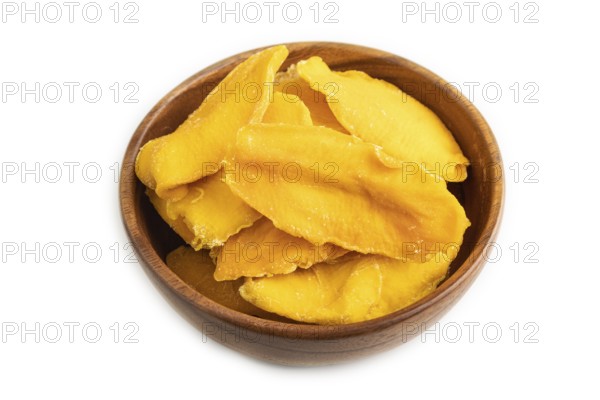 Dried Mango in wooden bowl isolated on white background. Side view, close up. healthy food, minimalism