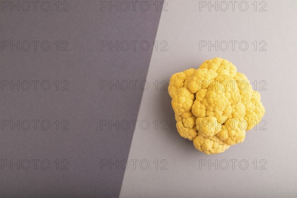 Yellow Cauliflower on black and gray pastel paper background. Top view, flat lay, copy space. healthy food, vegetable, minimalism