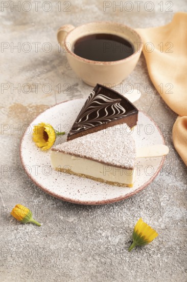 Chocolate and Vanilla Cake pops Marshmallow with cup of coffee on brown concrete background and orange linen textile. side view, close up