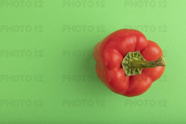 Red pepper on green pastel background. Top view, flat lay, copy space. healthy food, vegetable, minimalism