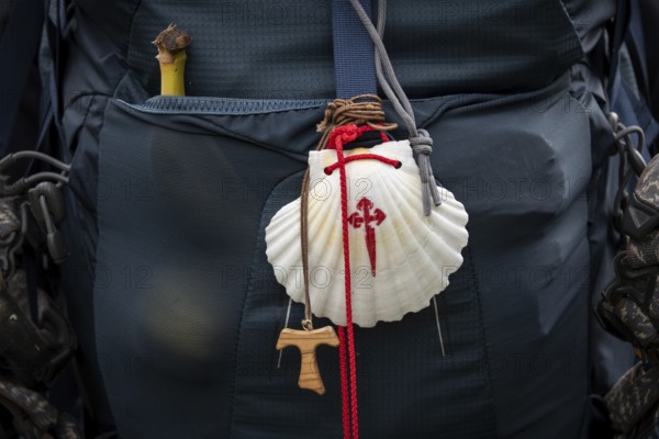Back of a rucksack with banana, scallop shell and olive wood dew cross, pilgrimage route Olavsweg or Olavsleden, Norway