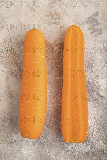 Orange Carrot on brown concrete background. Top view, close up, flat lay. healthy food, vegetable, minimalism
