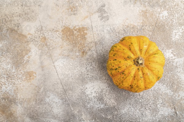 Orange Pumpkin on brown concrete background. Top view, copy space, flat lay. healthy food, vegetable, minimalism