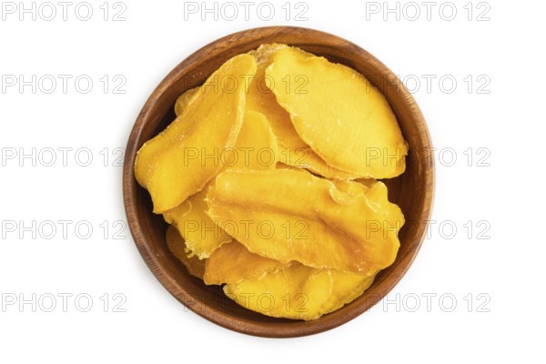 Dried Mango in wooden bowl isolated on white background. Top view, close up, flat lay. healthy food, minimalism