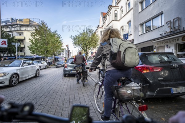 Cycling in the city, city centre road, cycle lane, two-wheeled traffic has priority, 30 km/h zone, cyclists' perspective, Essen, North Rhine-Westphalia, Germany