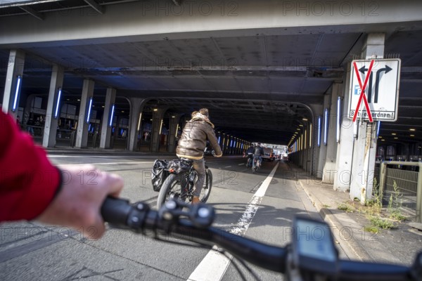 Riding a bike on a bike lane, at Essen main station, tunnel in the city centre of Essen, North Rhine-Westphalia, Germany