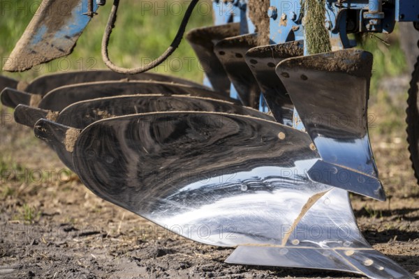 Plough, for ploughing a field, field, ploughshares, agricultural technology, shiny stainless steel, North Rhine-Westphalia, Germany