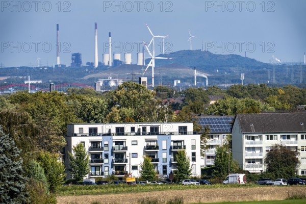 View over the western Ruhr area, from Essen-Haarzopf, housing estate with large photovoltaic system, over the north of Essen, to Gladbeck, Mottbruch spoil tip with wind turbine, to Gelsenkirchen, UNIPER coal-fired power station Scholven and wind turbines on the Scholven spoil tip, North Rhine-Westphalia, Germany
