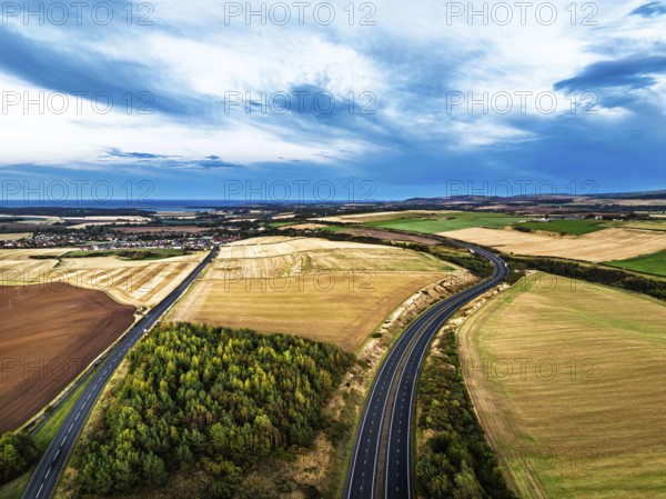 Sunset of Fields and Farms over Traprain Law and Hailes Castle from a drone, River Tyne, Haddington, East Lothian, Scotland, UK