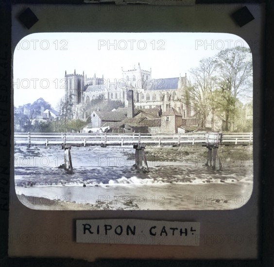 Colorised magic lantern slide of Ripon cathedral church from River Ure, Ripon, North Yorkshire, England, UK c 1900