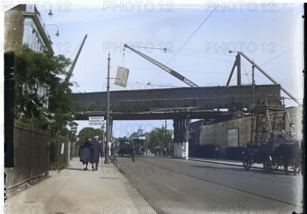 Construction or repair work on railway bridge, Finchley Road, Golders Green, London, England, UK 1920s or 1930s colourised version