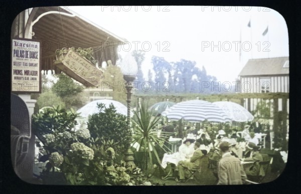 People enjoying pleasure gardens at the Karsino of Fred Karno, Tagg's Island, Molesley, London, England, UK 1920s or 1930s colourised
