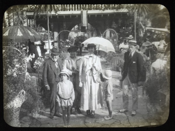 Family group standing in pleasure gardens at Karsino of Fred Karno, Tagg's Island, Molesley, London, England, UK 1920s or 1930s