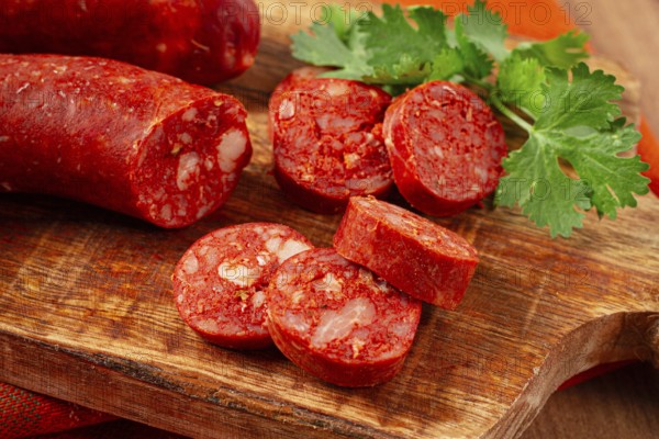 Spicy Chorizo sausage, on a cutting board, on a wooden table