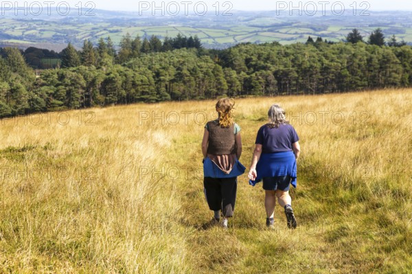 Two women, mother and daughter, walking on moorland in autumn, near Hayford, Buckfastleigh, Dartmoor national park, Devon, England, UK