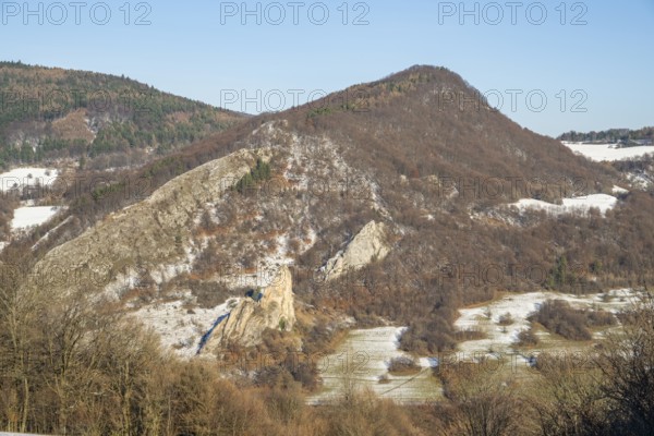 Cervenokamenské cliff (cervenokamenske bradlo), a huge rock at a mountain with bushes, trees and meadows in winter, Vápec, Horná Poruba, Slovakia