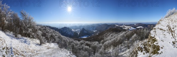View over the hills and valleys from the mountain with hoarfrost on the branches in winter, Vápec, Horná Poruba, Slovakia