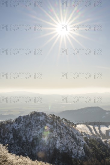 View over the hills and valleys from the mountain with hoarfrost on the branches in winter, Vápec, Horná Poruba, Slovakia