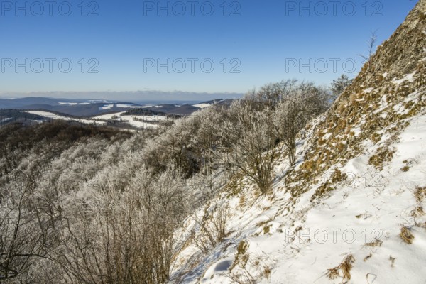 View over the hills and valleys from the mountain with hoarfrost on the branches in winter, Vápec, Horná Poruba, Slovakia