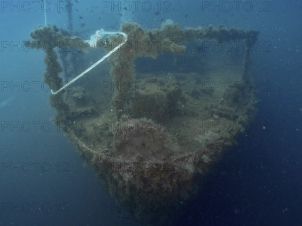 Bow of a shipwreck with rope and algae in blue water. Dive site wreck of the Vis, Pula, Croatia, Mediterranean Sea