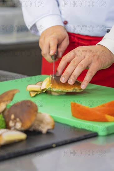 Person cutting mushrooms on a green cutting board