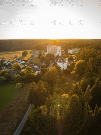 Aerial view of a village at sunset, surrounded by forests and fields, Tesla Model Y Juniper, Gechingen, Black Forest, Germany